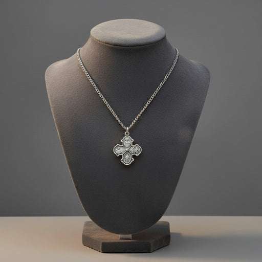 Silver necklace with a pendant on a gray mannequin bust against a gray background
