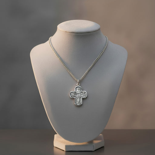 Silver cross necklace on a mannequin bust with a blurred background