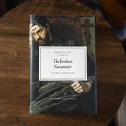 Book titled 'The Brothers Karamazov' on a wooden surface
