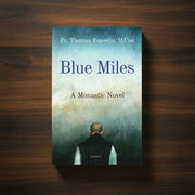 A blue book with text 'Blue Miles' on a dark wood surface