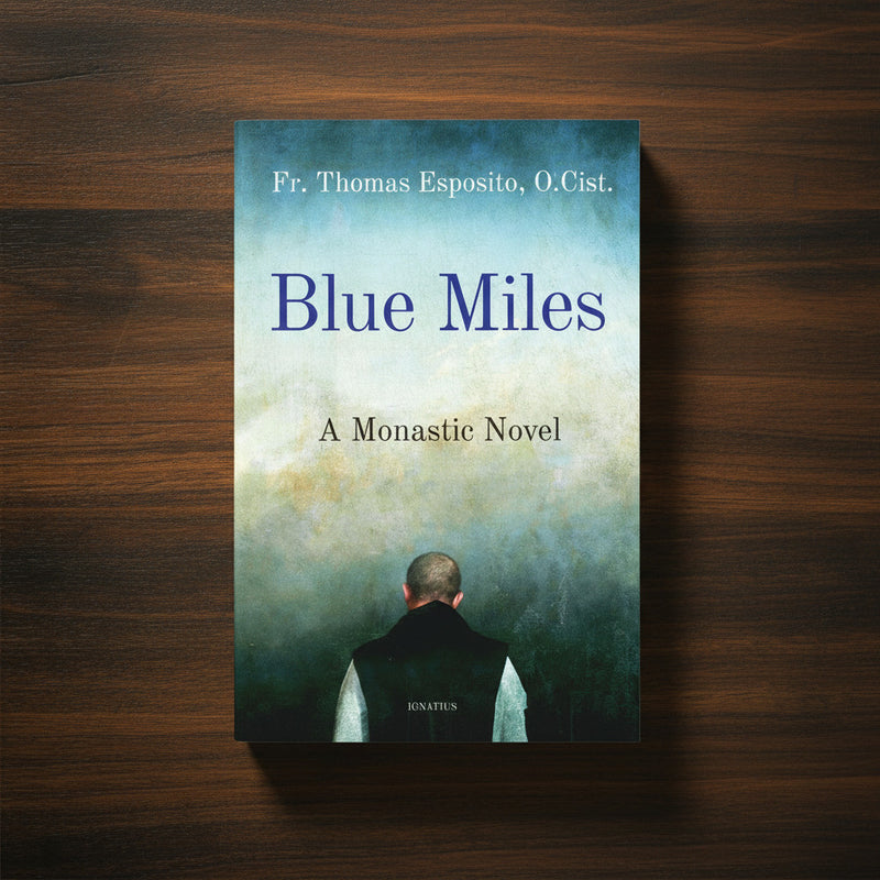 A blue book with text 'Blue Miles' on a dark wood surface