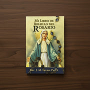 Book titled 'Mi Libro de Bolsillo del Rosario' on a wooden surface