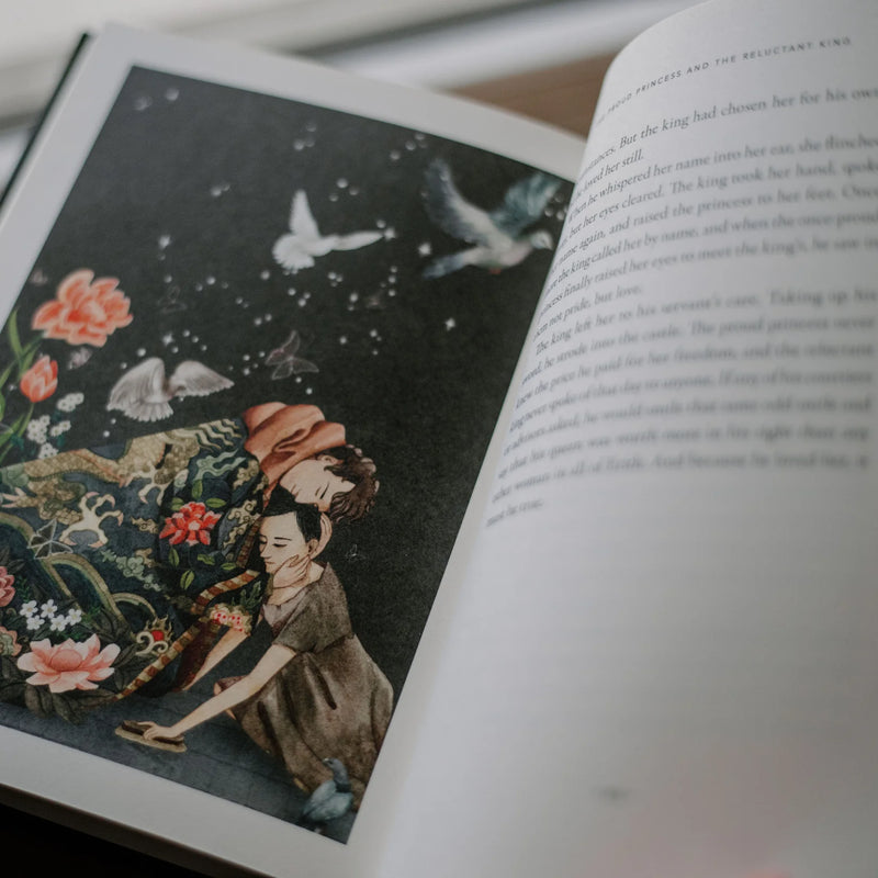 Open book with a colorful illustration of two people under a starry sky, surrounded by flowers and butterflies.