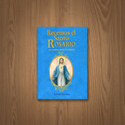 Blue book titled 'Recemos el Santo Rosario' on a wooden surface