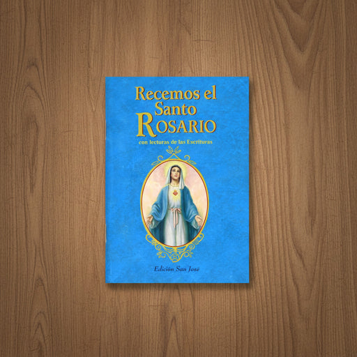 Blue book titled 'Recemos el Santo Rosario' on a wooden surface