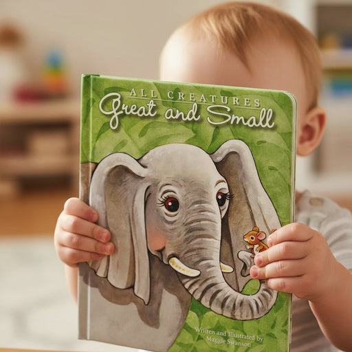 Child holding a book titled 'All Creatures Great and Small' with an elephant illustration on the cover.