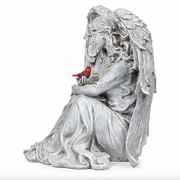 Statue of an angel holding a cardinal on a white background