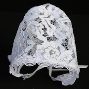 White lace baby baptism bonnet on a black background