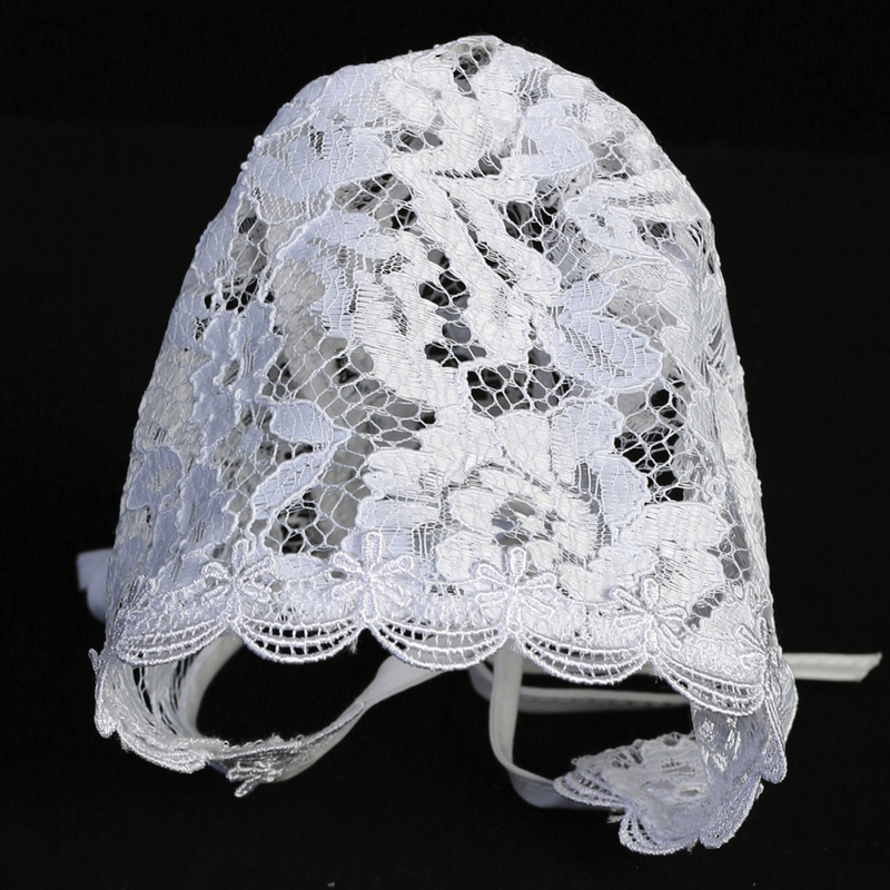 White lace baby baptism bonnet on a black background
