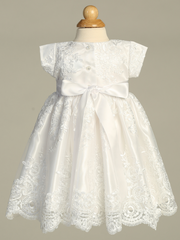 White baptism lace dress on a mannequin against a gray background