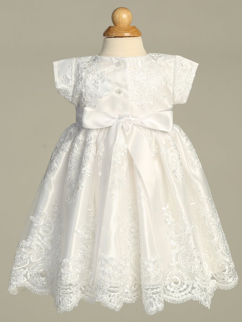White baptism lace dress on a mannequin against a gray background