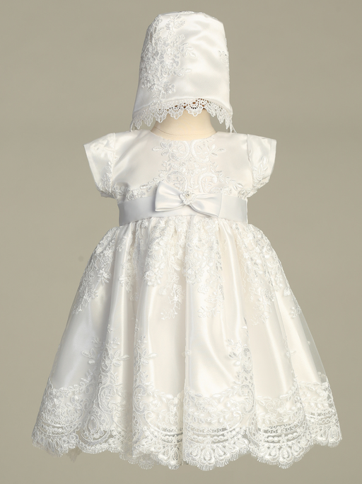 White lace baptism dress with matching bonnet on a mannequin against a gray background