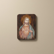 Wooden plaque with a painting of Jesus on a beige background