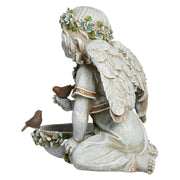 Statue of an angel with wings and birds on a white background