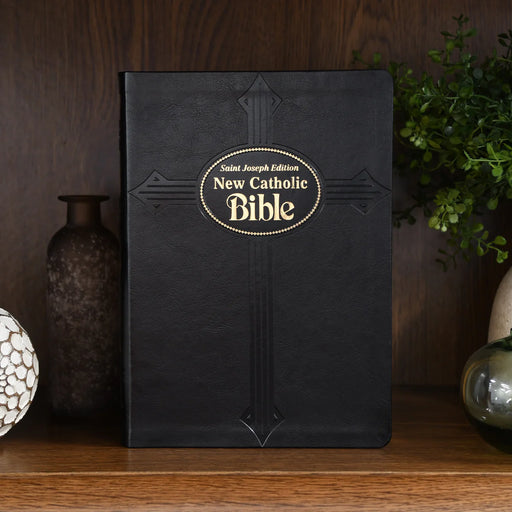 Large, black softcover Bible on a wood shelf.