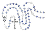 Blue and white First Communion girl's rosary on a white background.