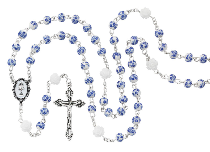 Blue and white First Communion girl's rosary on a white background.