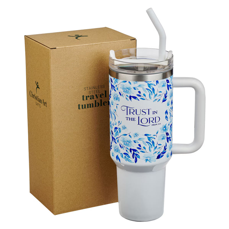White travel tumbler with blue floral design and 'Trust in the Lord' text, next to a cardboard box.