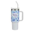 White tumbler with blue flowers and Bible verse on a white background
