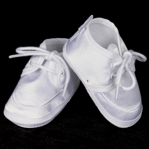 Pair of white baby shoes on a black background