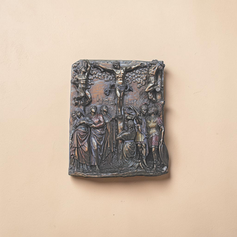 Bronze plaque with classical scene on a beige background