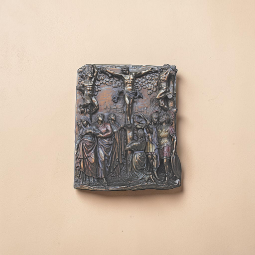 Bronze plaque with classical scene on a beige background