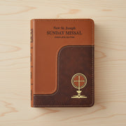 Brown leather-bound book titled 'New St. Joseph Sunday Missal Complete Edition' on a wooden surface