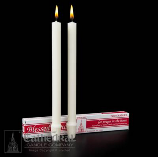 Two lit candles in front of their packaging box on a black background, with 'Cathedral Candle Company' branding.