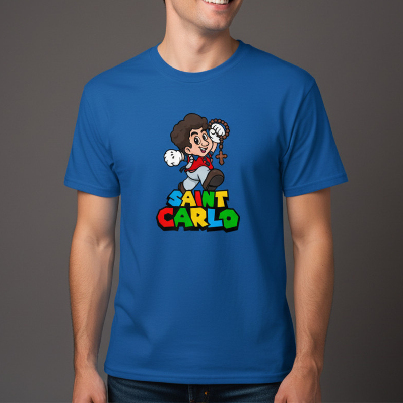 Person wearing a blue t-shirt with a cartoon depiction of Saint Carlo Acutis on a gray background