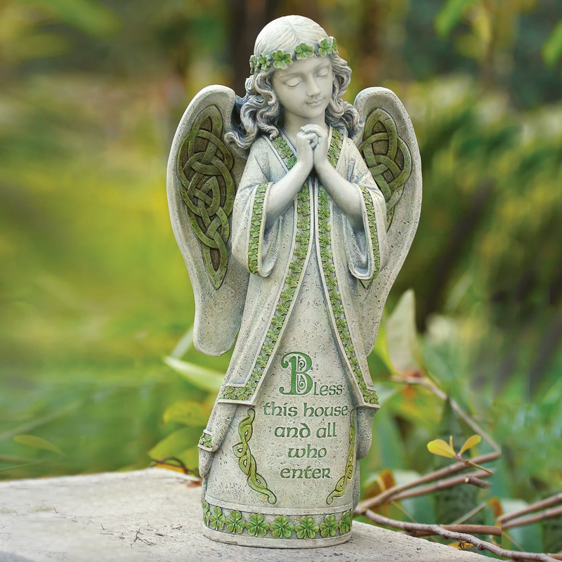 Decorative angel statue with green accents and text on a natural background