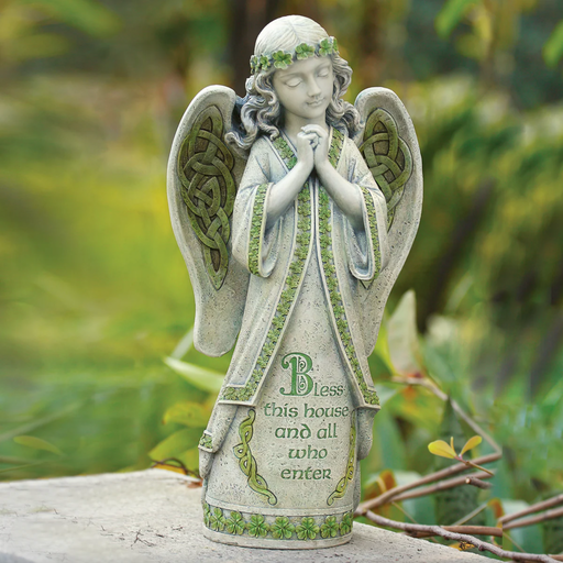 Decorative angel statue with green accents and text on a natural background