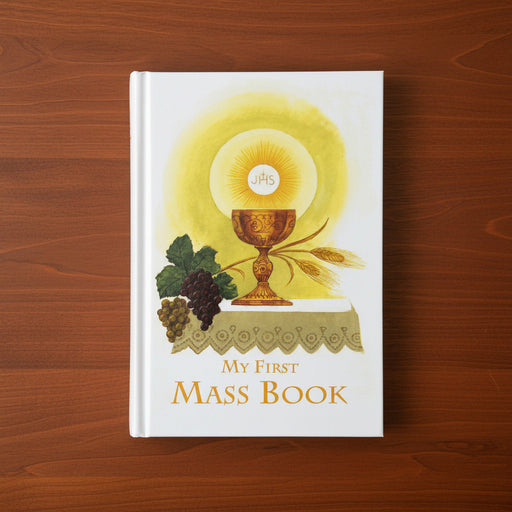 Book titled 'My First Mass Book' with religious illustration on a wooden surface
