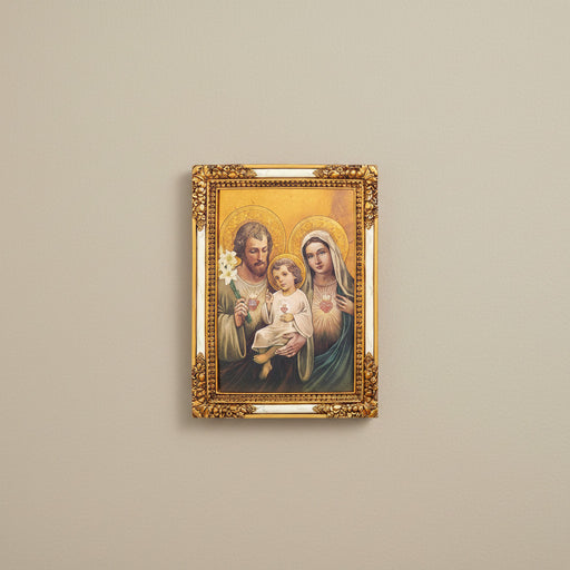Framed artwork of the Holy Family with gold frame on beige wall