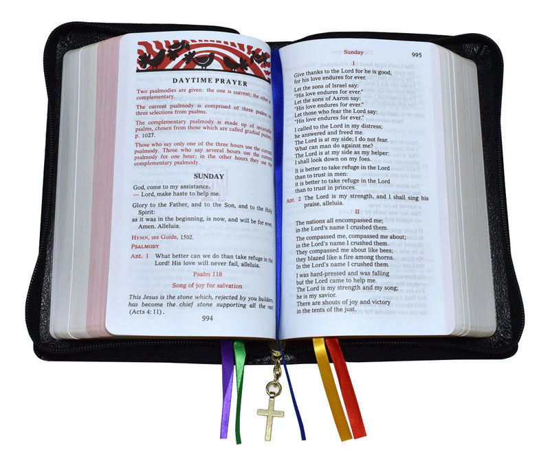 Open book with colorful bookmarks and a cross charm on a white background