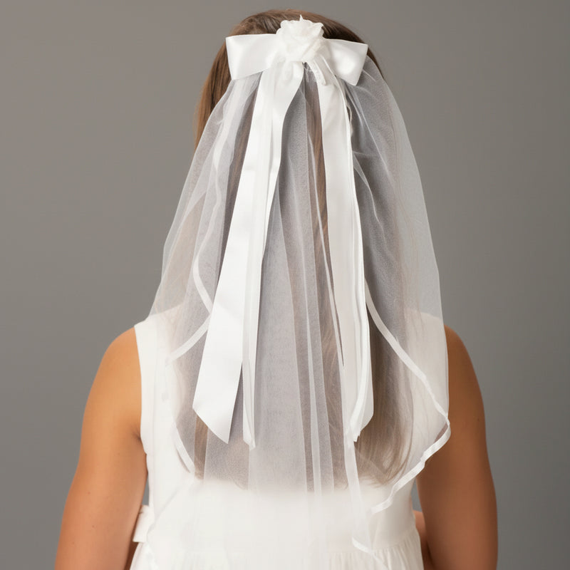 White veil with a large bow on a plain background