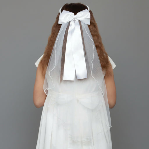 White Communion veil with a large bow on a gray background