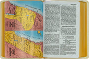 Open book with a map of the Holy Land on one page and text on the other, set against a wooden background.