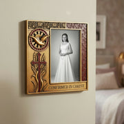 A hand adjusts a Confirmation picture frame hanging on a beige wall