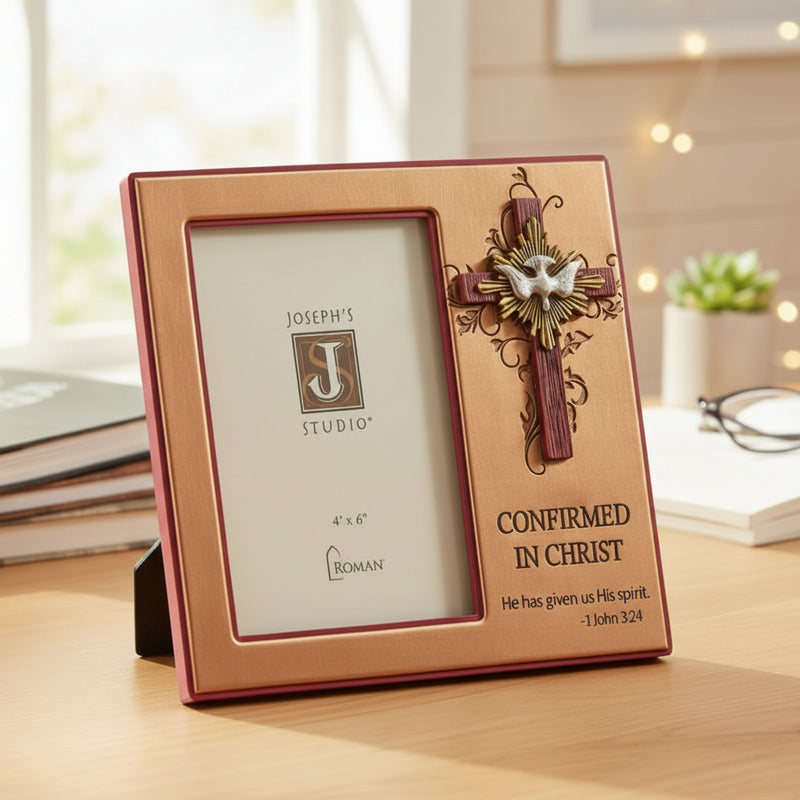 Decorative Confirmation photo frame with cross design held by a hand on a wooden surface.