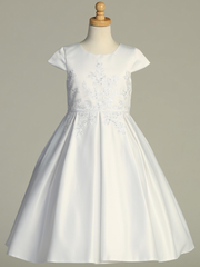 White Communion dress with floral lace details on a mannequin against a gray background