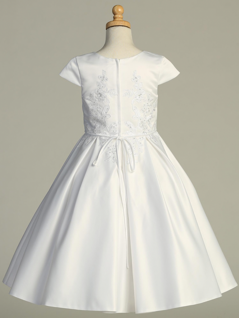 White Communion dress on a mannequin against a gray background