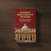 Book titled 'Favorite Indulged Prayers' with a cathedral image on a wooden background
