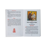 Open book with text and a Saint Anthony of Padua illustration on a white background