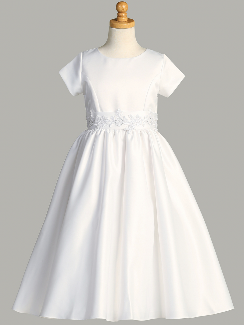 A white belted First Holy Communion dress on a gray background.