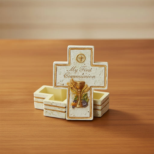 Decorative cross shaped First Communion keepsake box on a wood surface
