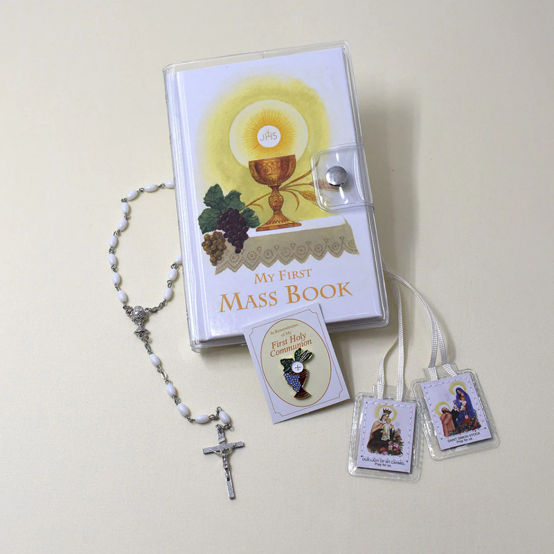 My First Mass Book with rosary and prayer cards on a light background