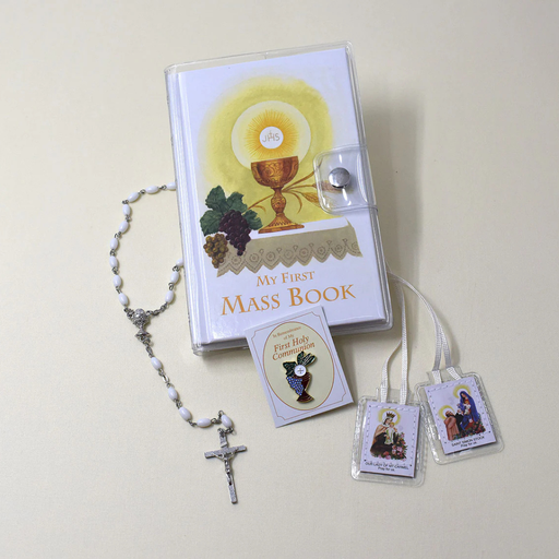 My First Mass Book with rosary and prayer cards on a light background