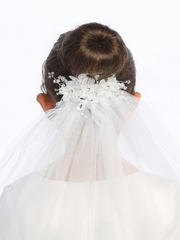 Close-up on the floral details of a little girl's white sheer First Communion veil