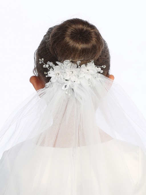 Close-up on the floral details of a little girl's white sheer First Communion veil