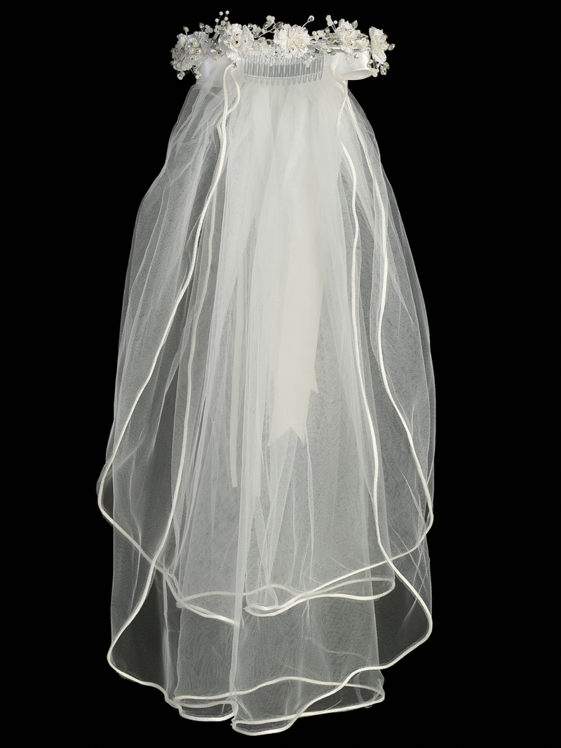 Full length white communion veil with corded flowers, pearls, and rhinestones, featuring a satin bow at the back.